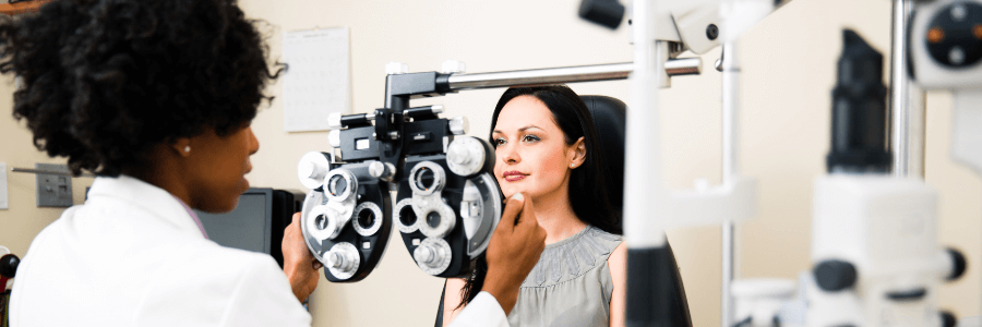 Optometrist performing eye exam on patient