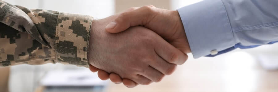 Soldier and businessman shaking hands