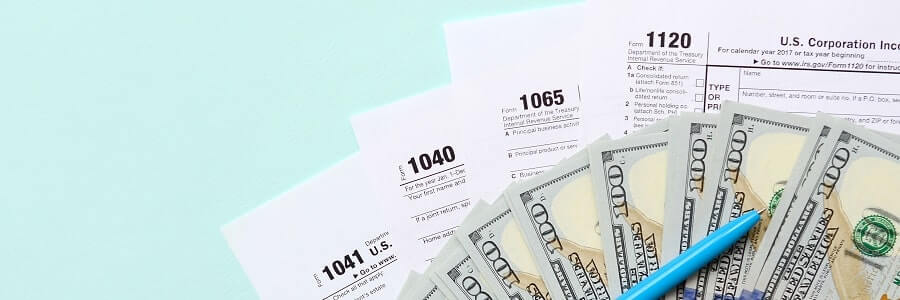 Tax return documents with pen and cash