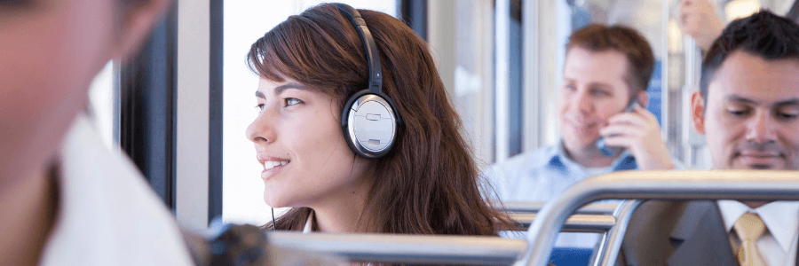 Woman commuting on bus listening to headphones